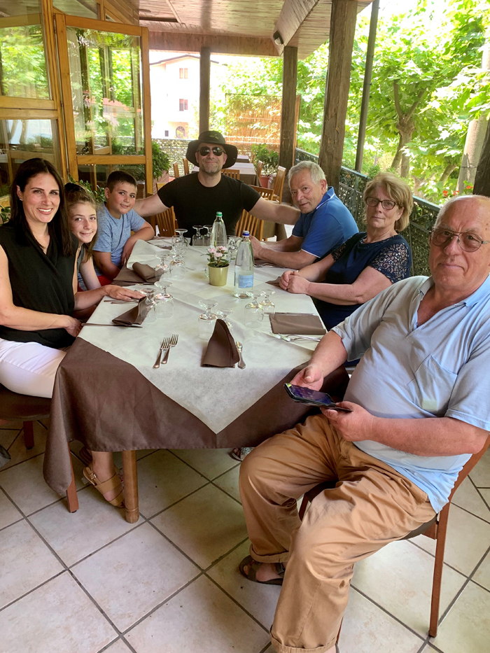 Michelle and six others are seated around a dining table